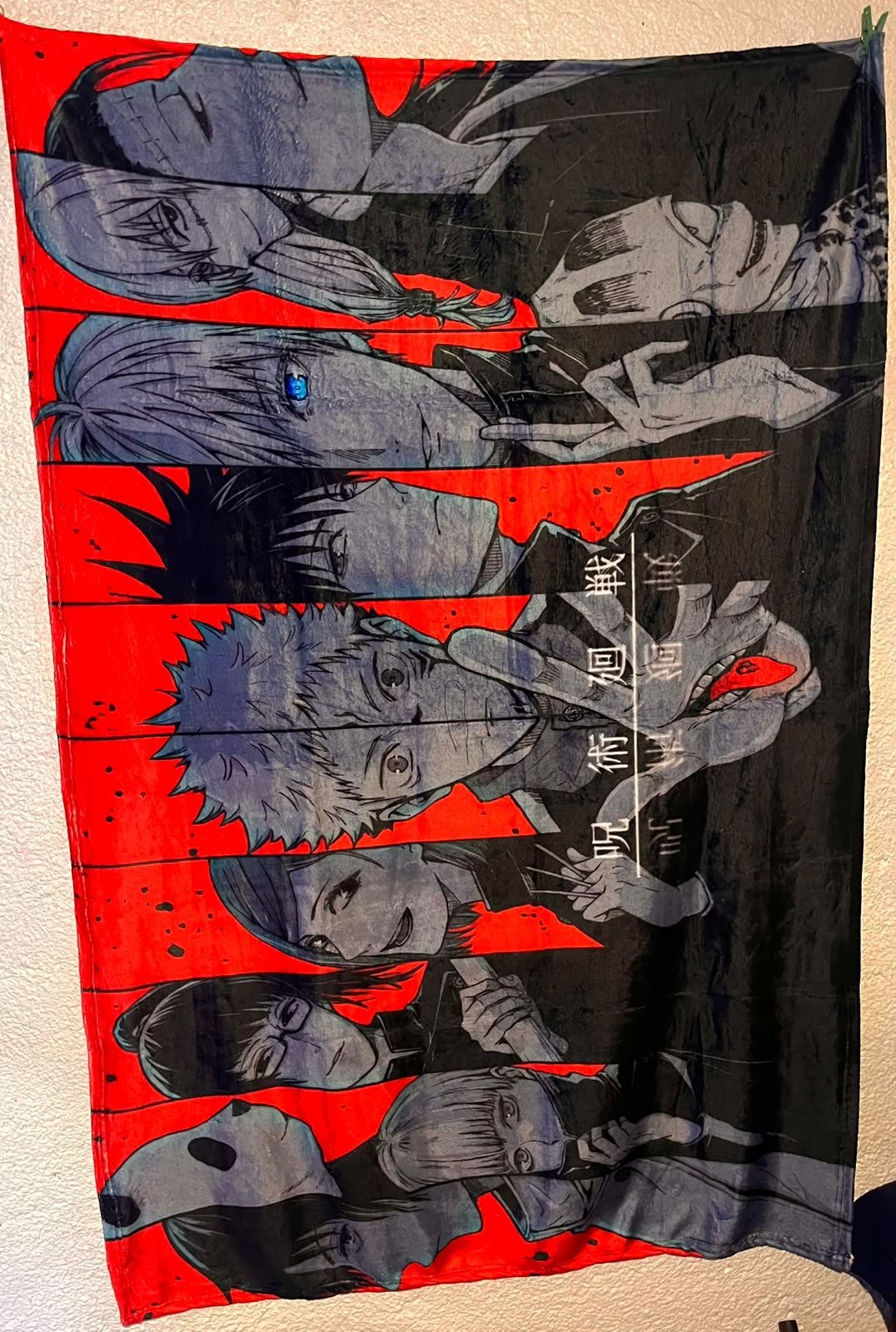 Frazada viajera anime: personajes de Jujutsu Kaisen en franjas rojas y grises — foto de la frazada real